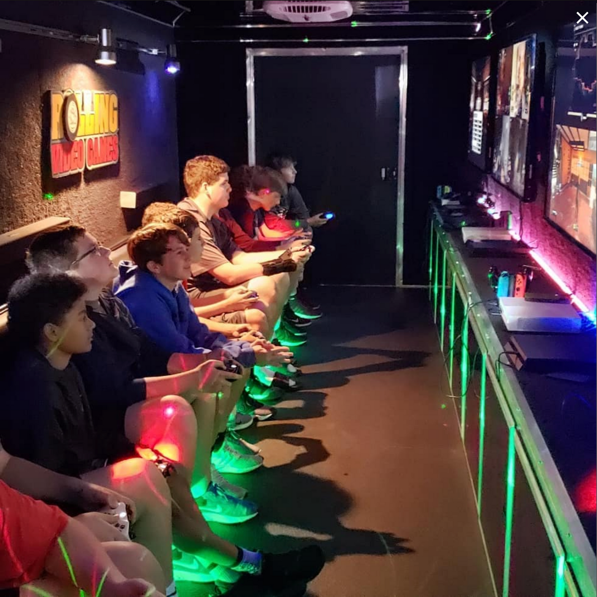Kids playing video games inside the Rolling Video Games trailer